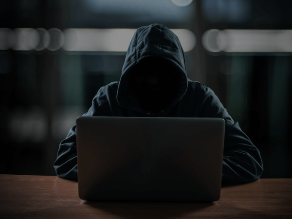 Illustration of a cyber threat or hacker on a laptop
